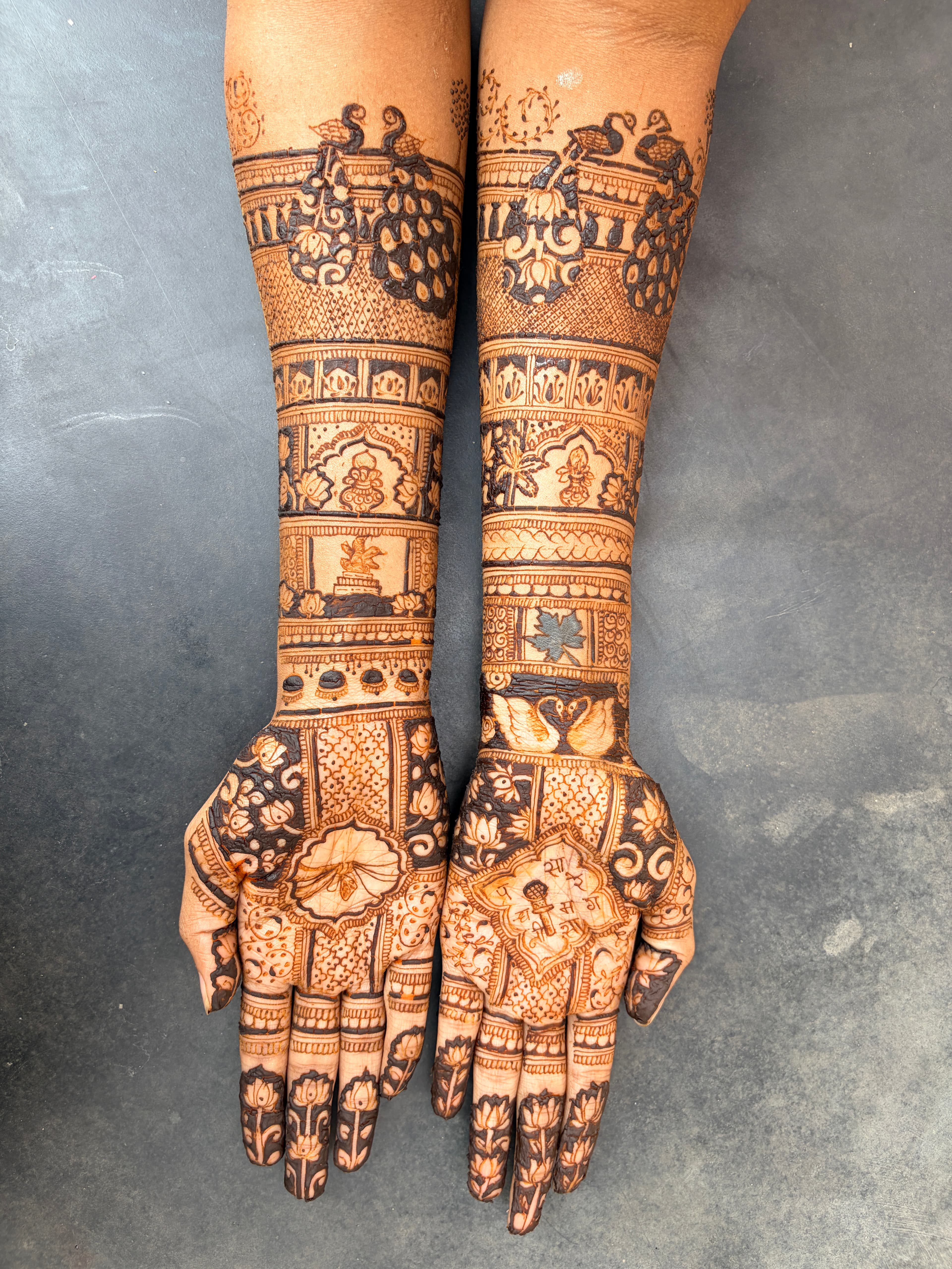 Full-length royal wedding bridal arms mehendi design by Royal Hands By Dhanashree